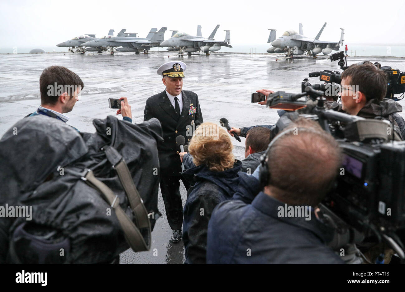 Rear Admiral Eugene H. 'Gene' Black, Commander, Carrier Strike Group 8, talks to the media on the flight deck of the US Nimitz-class aircraft carrier USS Harry S. Truman, following its arrival into Stokes bay, Hampshire, during a visit to Portsmouth. Stock Photo