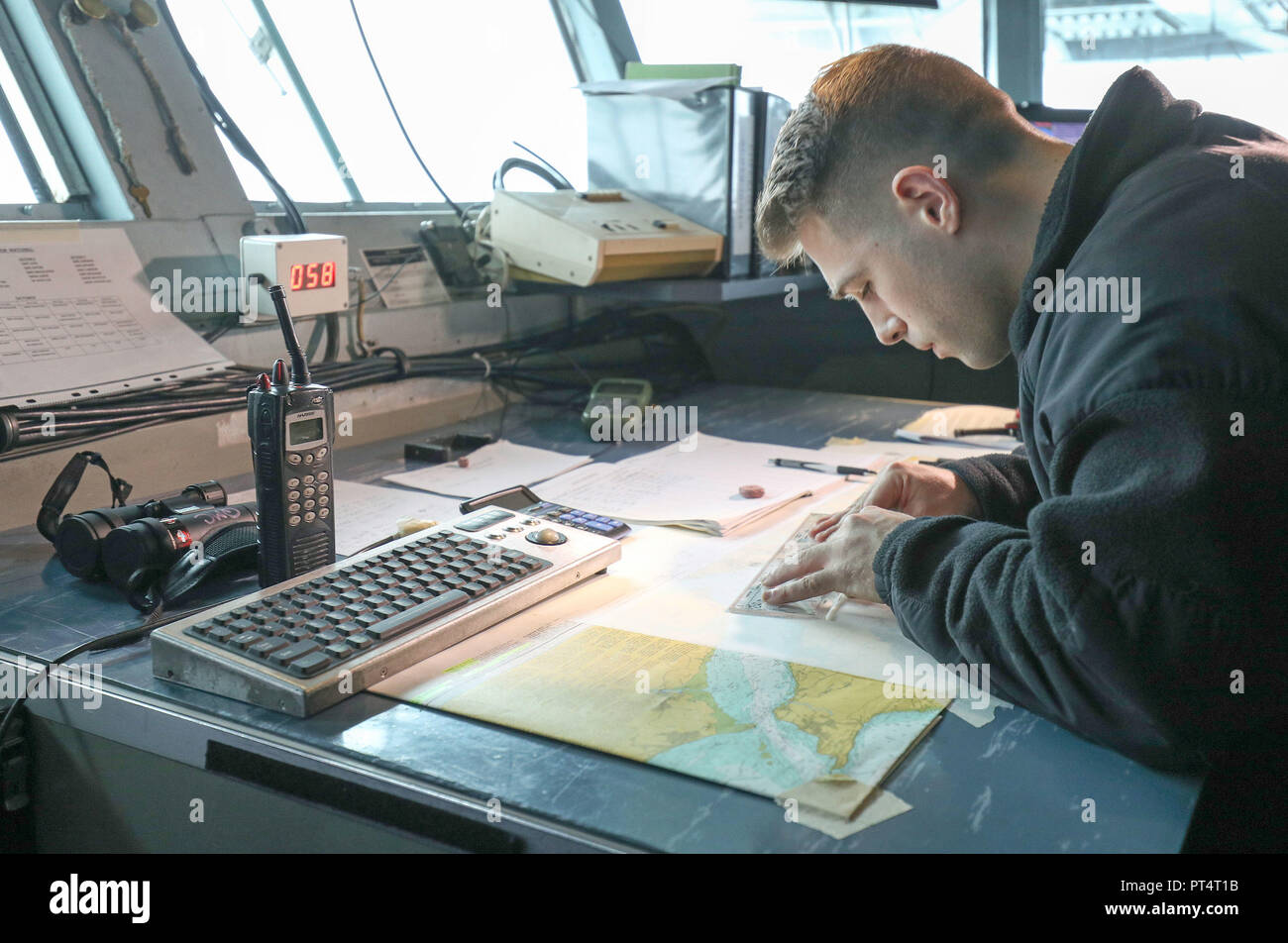 A member of the crew plots a course on board the US Nimitz-class aircraft carrier USS Harry S. Truman, after its arrival into Stokes bay, Hampshire, during a visit to Portsmouth. Stock Photo