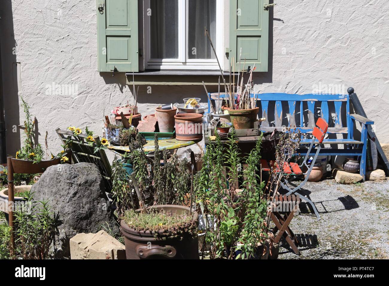 pots and plants at the front of a house Stock Photo