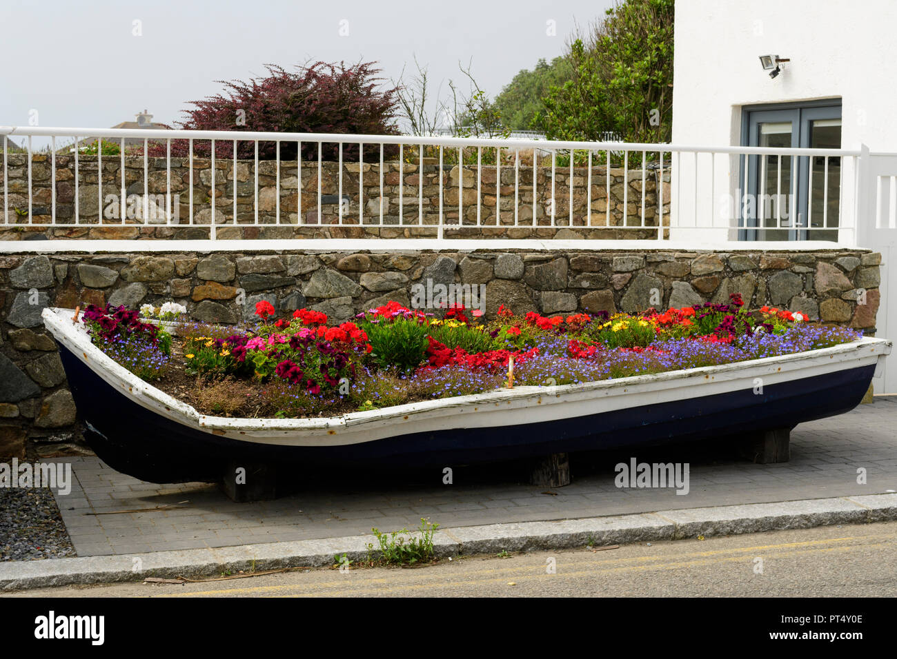 Rowing boat wreck filled with flowers in Kilmore Quay, Co. Wexford, Ireland Stock Photo