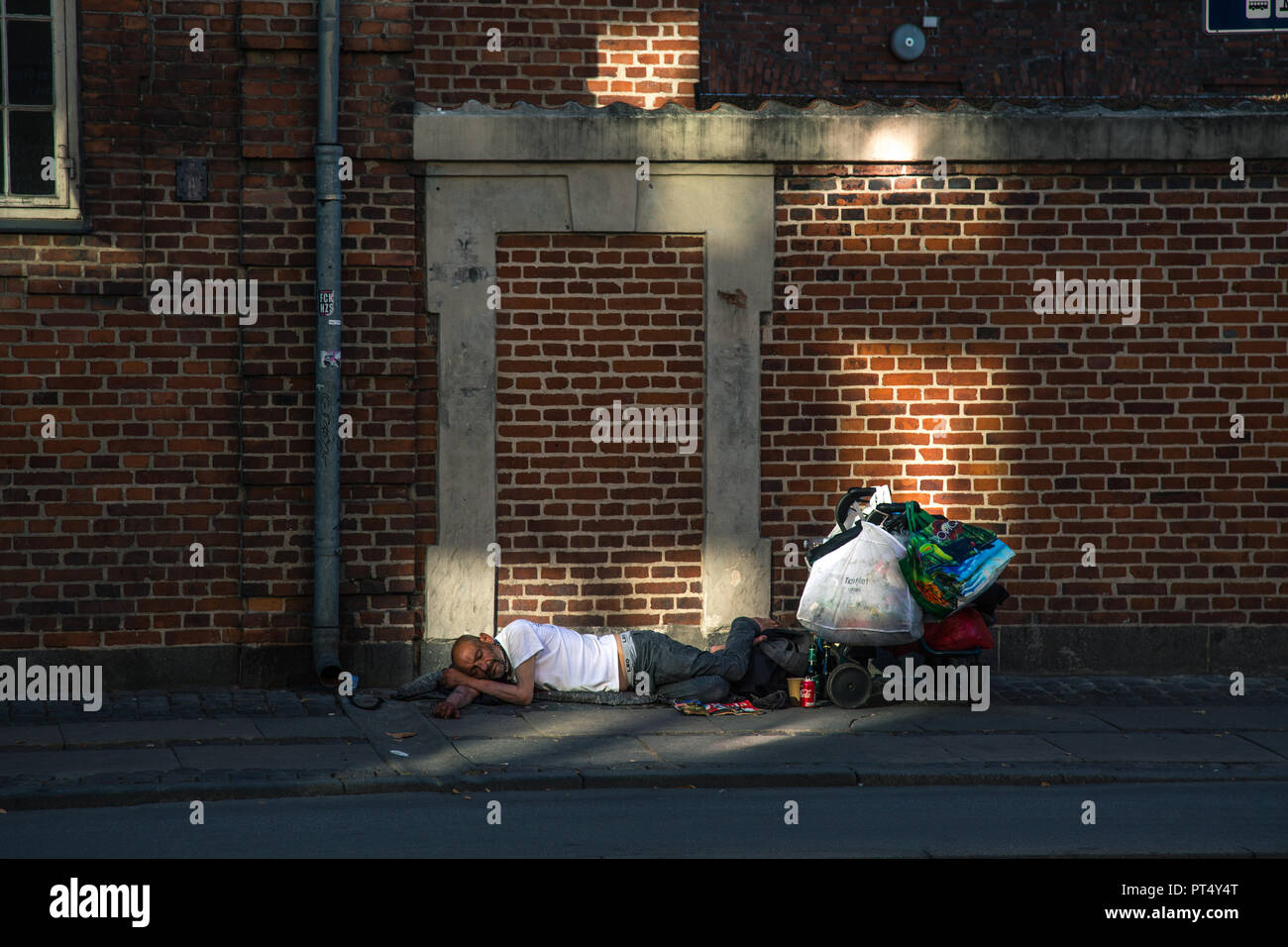 homeless asleep on the sidewalk in copenhagen Stock Photo
