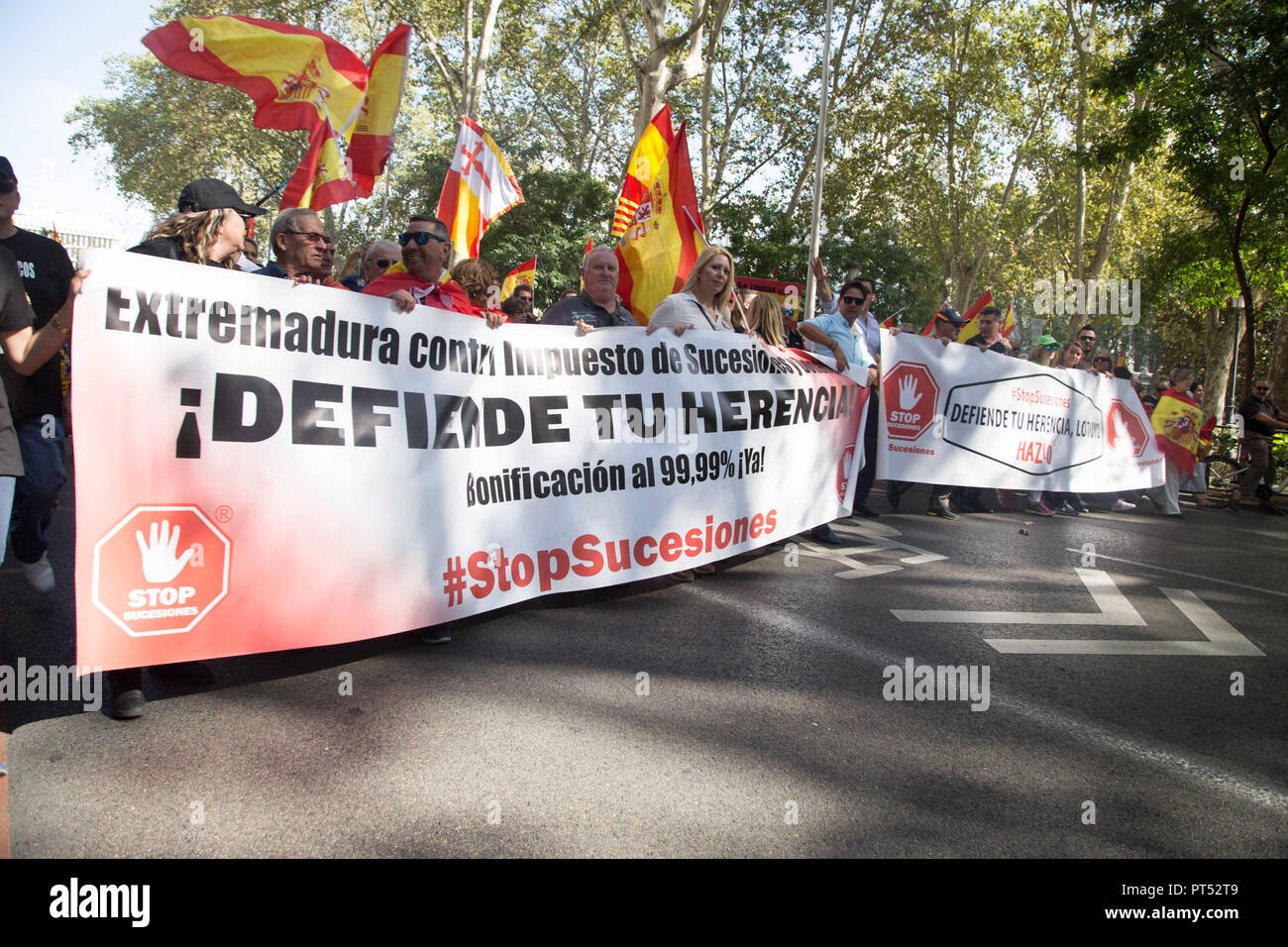October 6, 2018 - Madrid, Spain - Protesters are seen holding banner and flags during the protest..Millions of people with Spanish constitutional and Falangist flags demonstrated in Madrid against the Spanish government of Pedro Sanchez, for the unity of the country and against the inheritance tax. The demonstration stated at the Plaza de ColÃ³n to the Congress of Deputies. (Credit Image: © Lito Lizana/SOPA Images via ZUMA Wire) Stock Photo