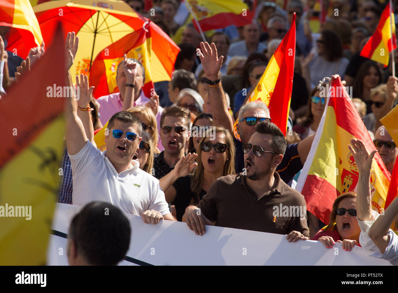 October 6, 2018 - Madrid, Spain - Protesters are seen holding flags shouting during the protest..Millions of people with Spanish constitutional and Falangist flags demonstrated in Madrid against the Spanish government of Pedro Sanchez, for the unity of the country and against the inheritance tax. The demonstration stated at the Plaza de ColÃ³n to the Congress of Deputies. (Credit Image: © Lito Lizana/SOPA Images via ZUMA Wire) Stock Photo