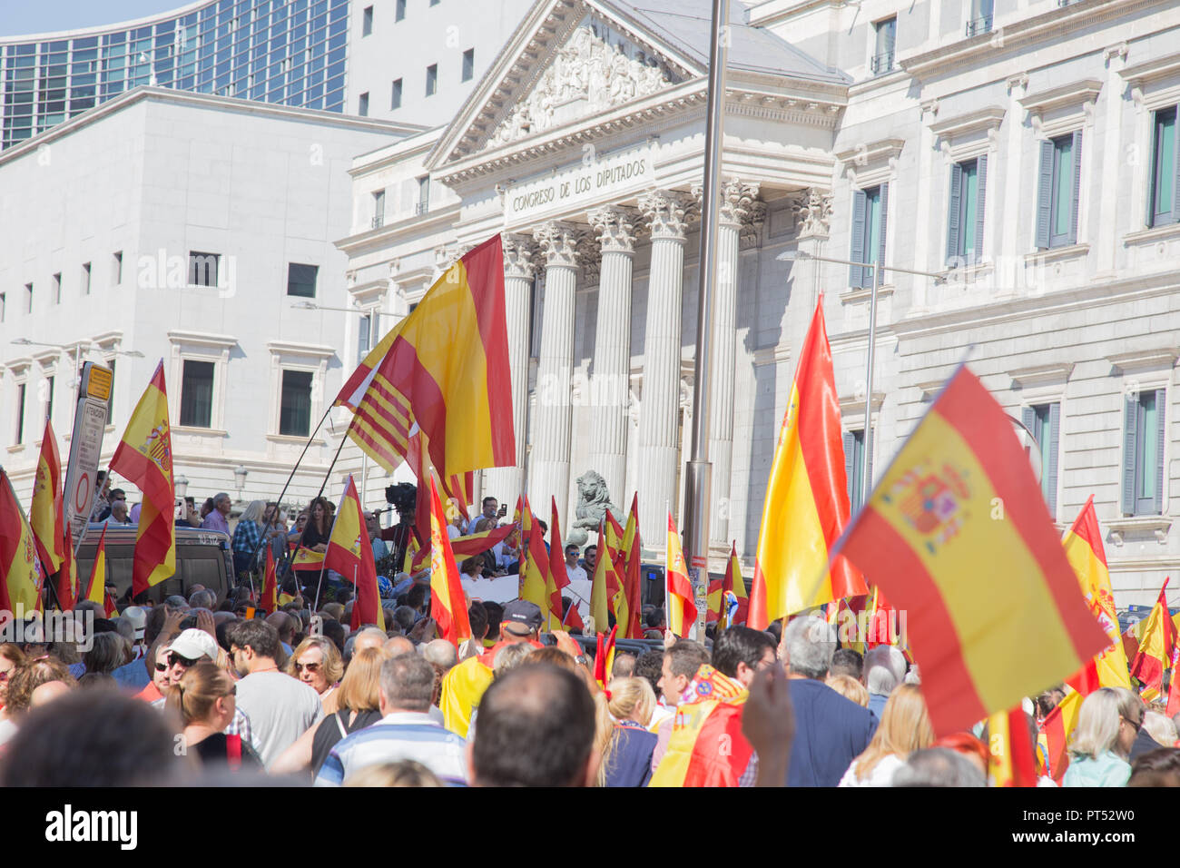 October 6, 2018 - Madrid, Spain - Protesters are seen standing next to the Congress of Deputies during the protest..Millions of people with Spanish constitutional and Falangist flags demonstrated in Madrid against the Spanish government of Pedro Sanchez, for the unity of the country and against the inheritance tax. The demonstration stated at the Plaza de ColÃ³n to the Congress of Deputies. (Credit Image: © Lito Lizana/SOPA Images via ZUMA Wire) Stock Photo