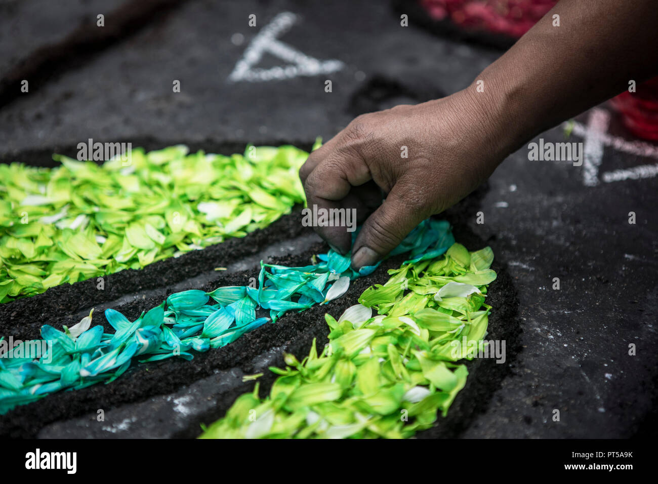 Lima, Peru. 6th October 2018. Devotees making a carpet of flowers, outside the church where the image of the Lord of the Miracles will start the procesion. Every October for the past four centuries this procession takes place in Lima and is known as the most important religious event in Peru. This Peruvian tradition commemorates the devastating 1746 Lima earthquake which left only a mural of Christ standing in a city area. Credit: SOPA Images Limited/Alamy Live News Stock Photo