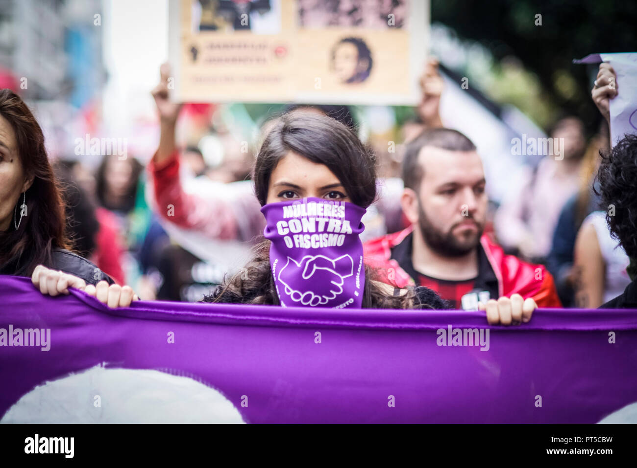 Sao Paulo, Brazil. 06th Oct, 2018. A woman wearing a scarf with the inscription "Mulheres contra o fascismo" ("Women Against Fascism") takes part in a demonstration against the extreme right-wing presidential candidate Bolsonaro. Many people in Sao Paulo took to the streets against Bolsonaro and his racist, anti-woman and anti-gay course. In the midst of a severe crisis, Latin America's largest country elects a new president. On 07.10.2018 the ultra-right Bolsonaro and the left Haddad will be the favourites in the presidential elections. Credit: Pablo Albarenga/dpa/Alamy Live News Stock Photo