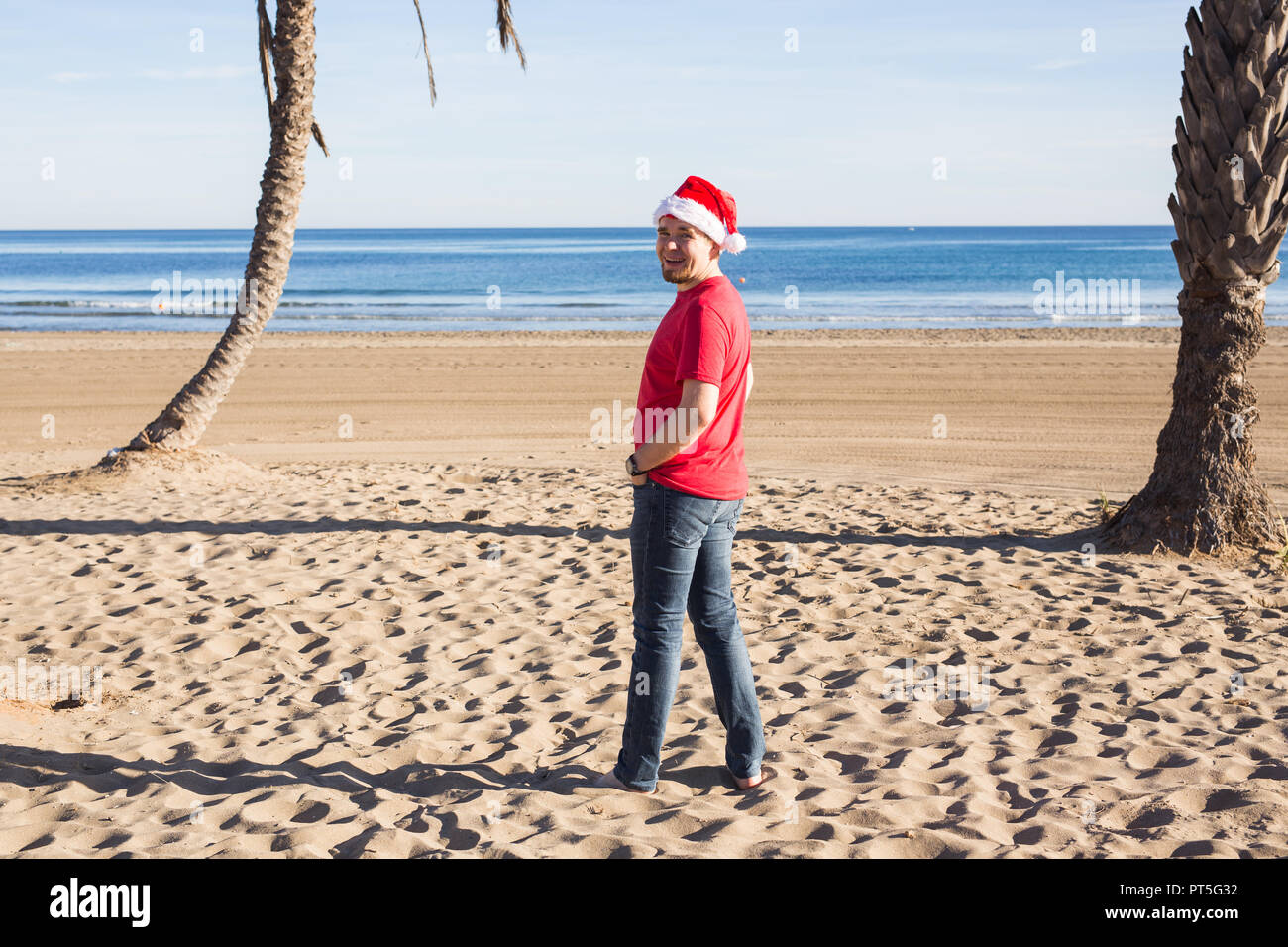 Christmas, humor, holidays concept - Man in Santa hat on the beach ...