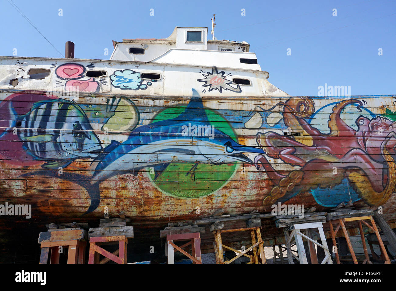 Old fishing cutter painted with marine animals motives at harbour of fishing village Aci Trezza, comune of Aci Castello, Catania, Sicily, Italy Stock Photo