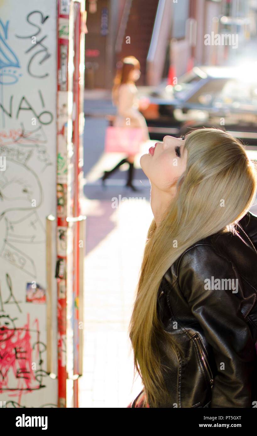Japanese Girl poses on the street in Shibuya, Japan. Shibuya is a town ...