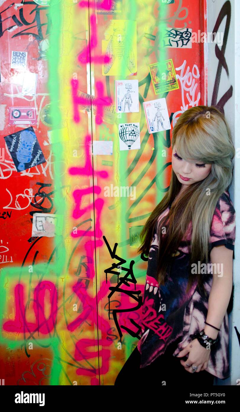 Japanese Girl poses on the street in Shibuya, Japan. Shibuya is a town ...