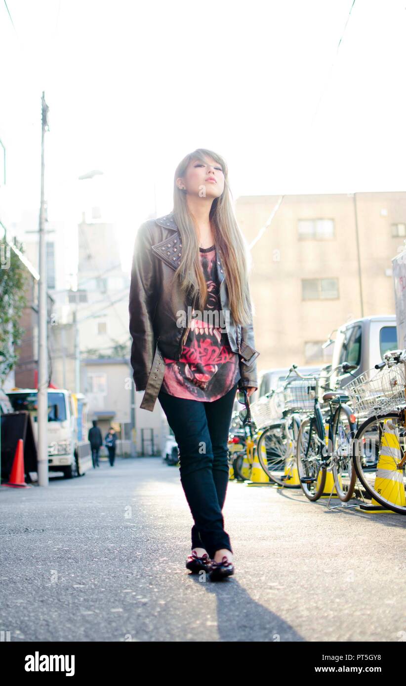 Japanese Girl poses on the street in Shibuya, Japan. Shibuya is a town ...