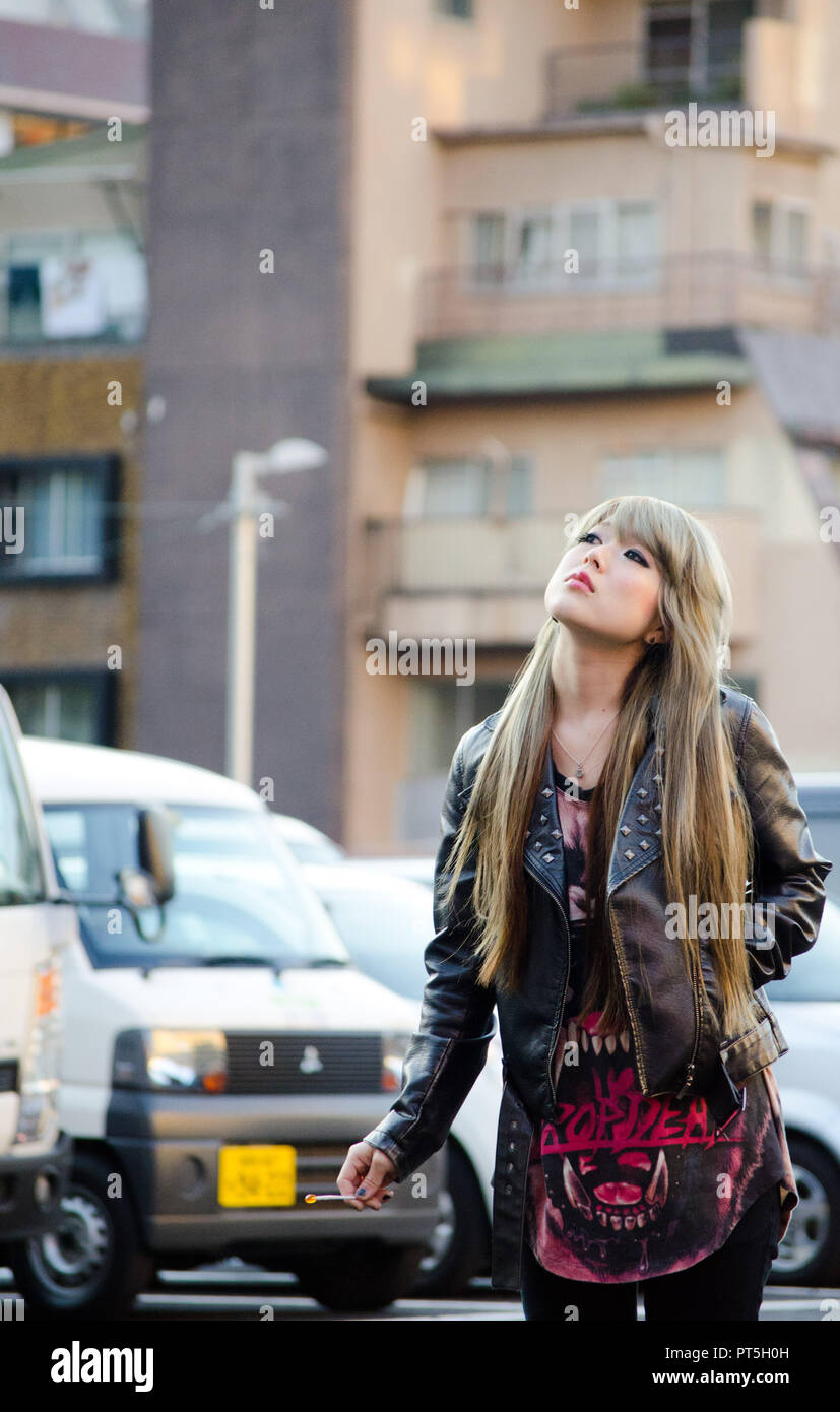 Japanese Girl poses on the street in Shibuya, Japan. Shibuya is a town ...