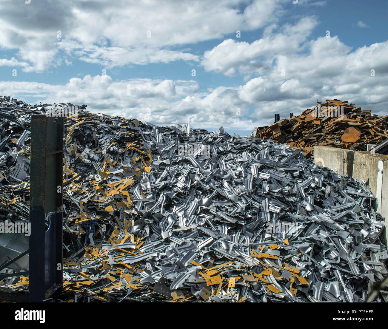 Heaps of steel (ferrous) and non-ferrous scrap metal in a scrapworks. Stock Photo