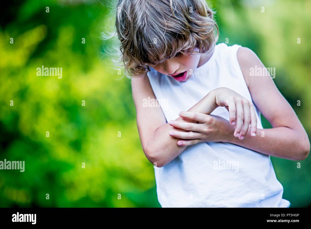 Young boy scratching arm. Stock Photo