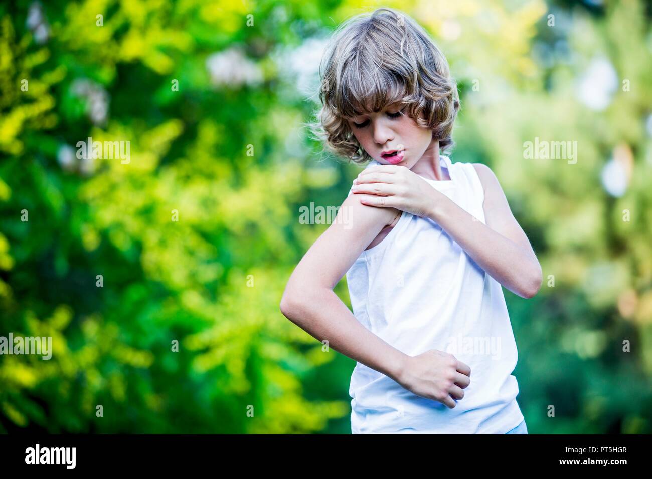 Young boy scratching arm. Stock Photo