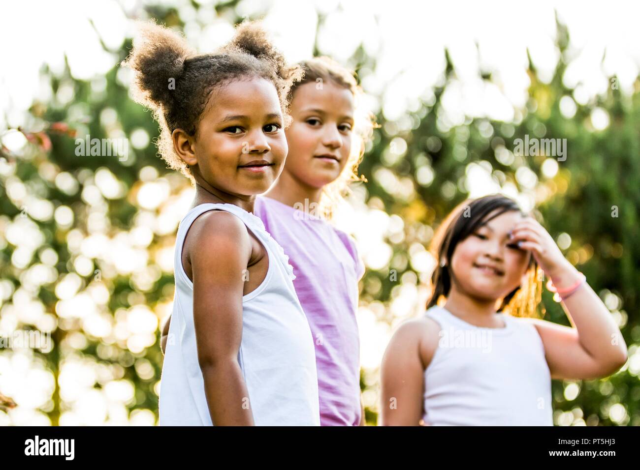 Portrait of girls smiling together in park while playing. Stock Photo