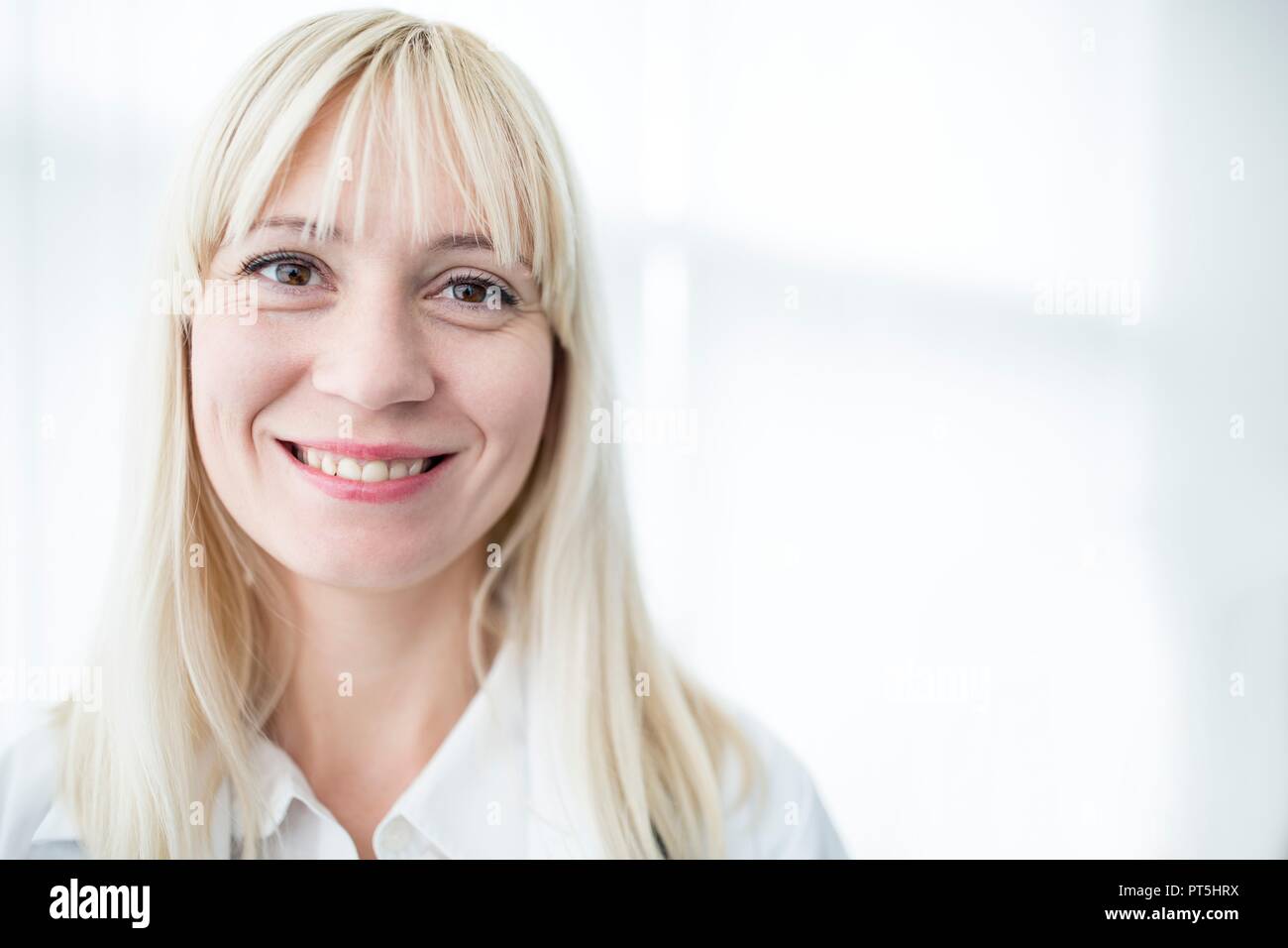 Portrait of female doctor smiling towards camera. Stock Photo