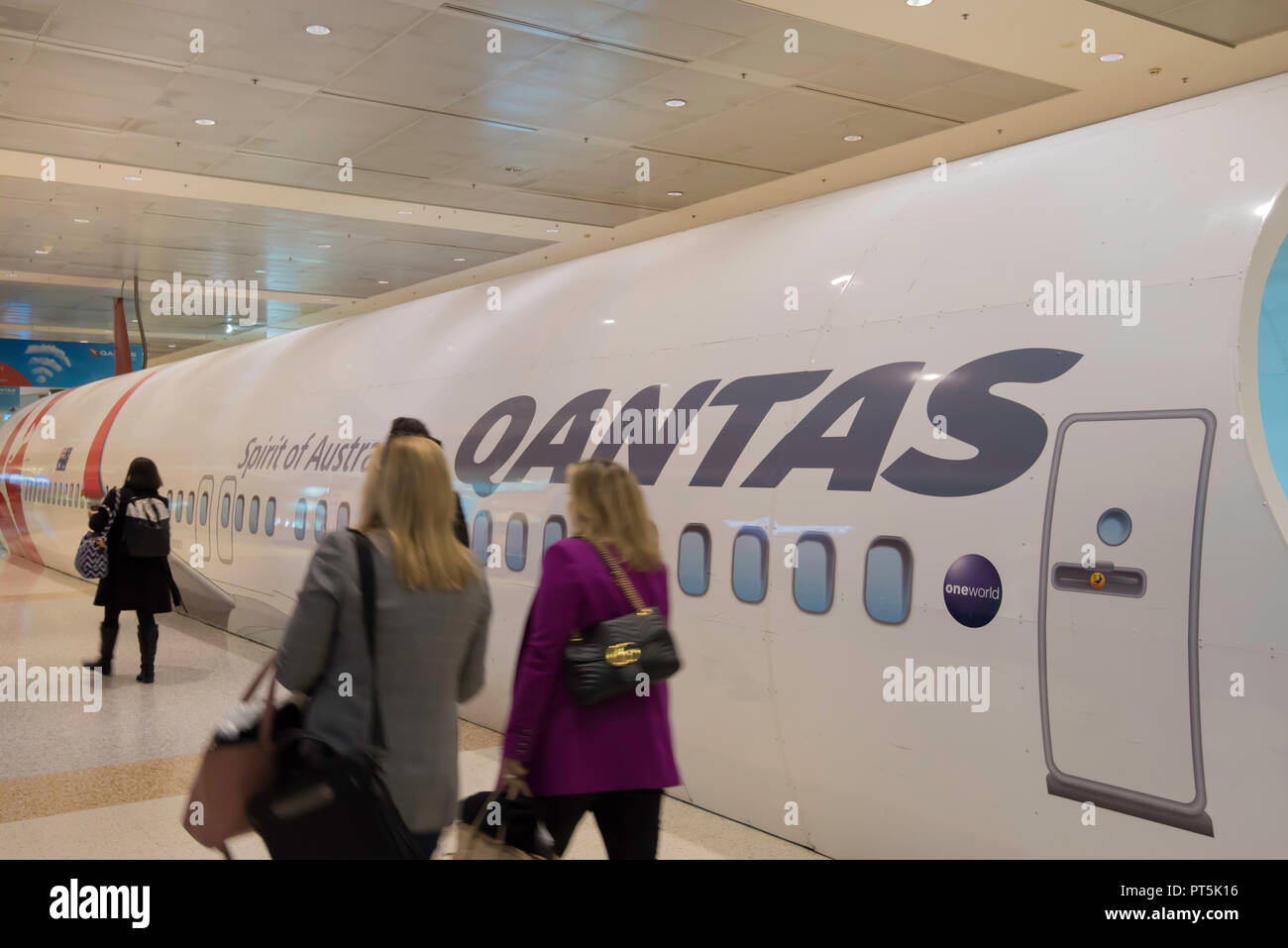 A mock up of a Qantas plane fuselage that covers a moving footway inside the departure area airside at Sydney Domestic Airport in Australia Stock Photo