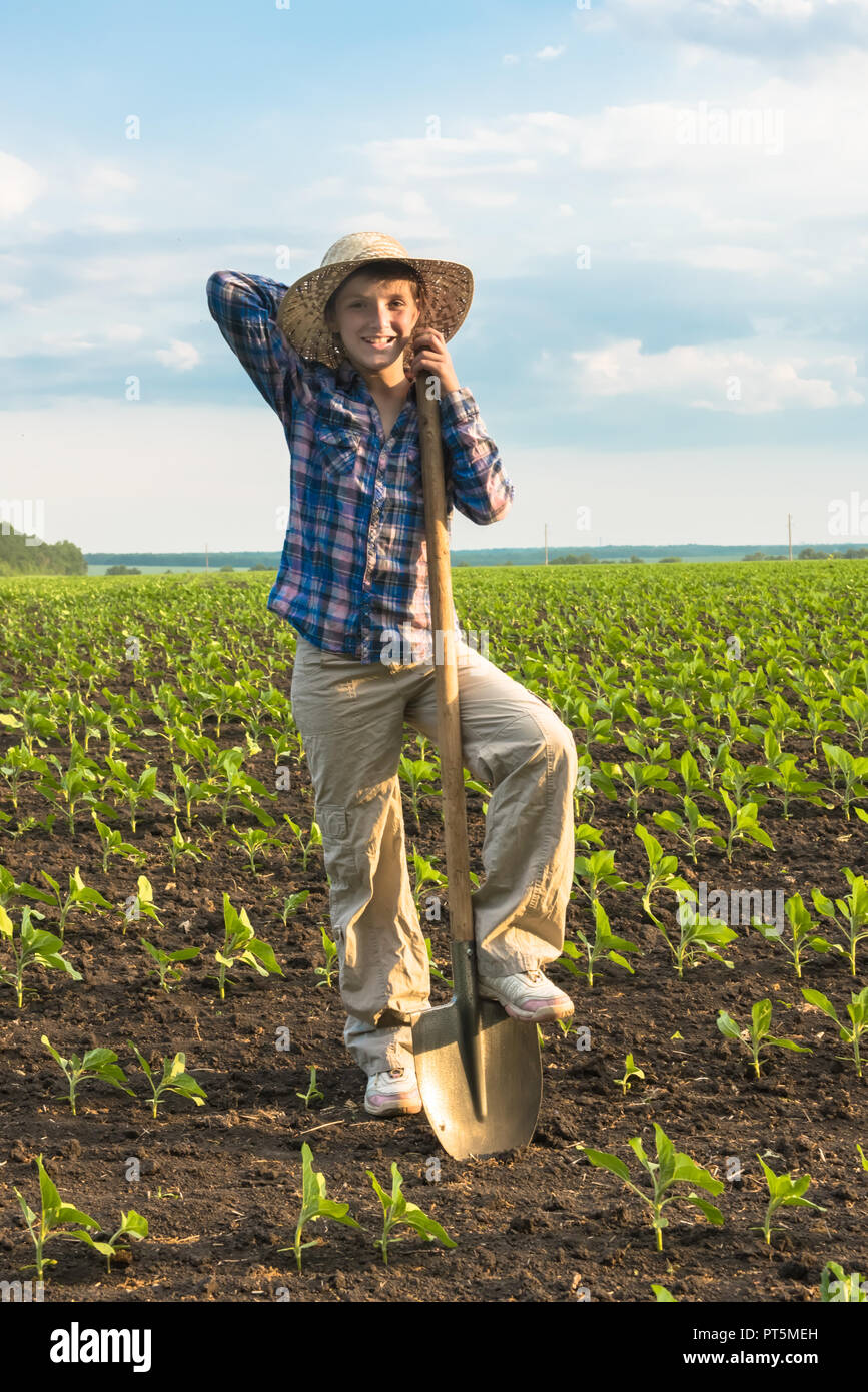 Happy small farmer with spade in spring field Stock Photo Alamy