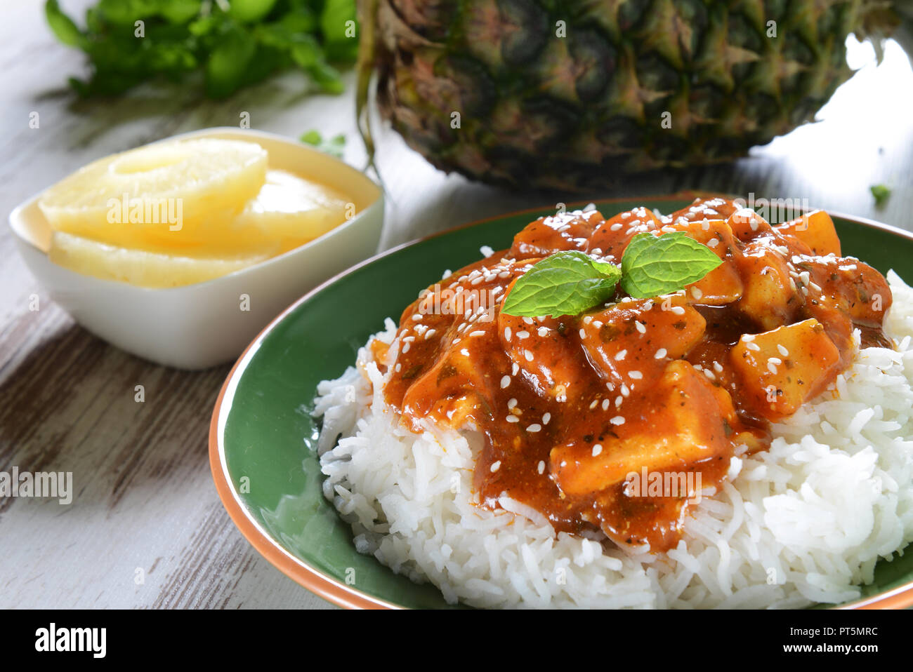 Chicken in caribbean style with pineapple and rice Stock Photo Alamy