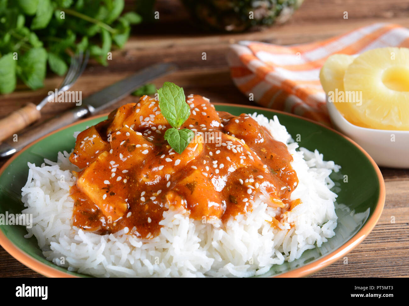Chicken in caribbean style with pineapple and rice Stock Photo Alamy