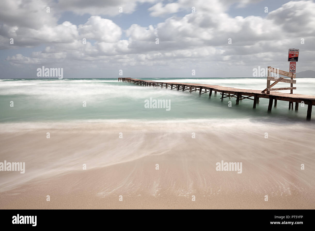 Europe Spain North Mallorca Playa de Muro, long wooden jetty in the bay of Alcudia during violent storm Stock Photo