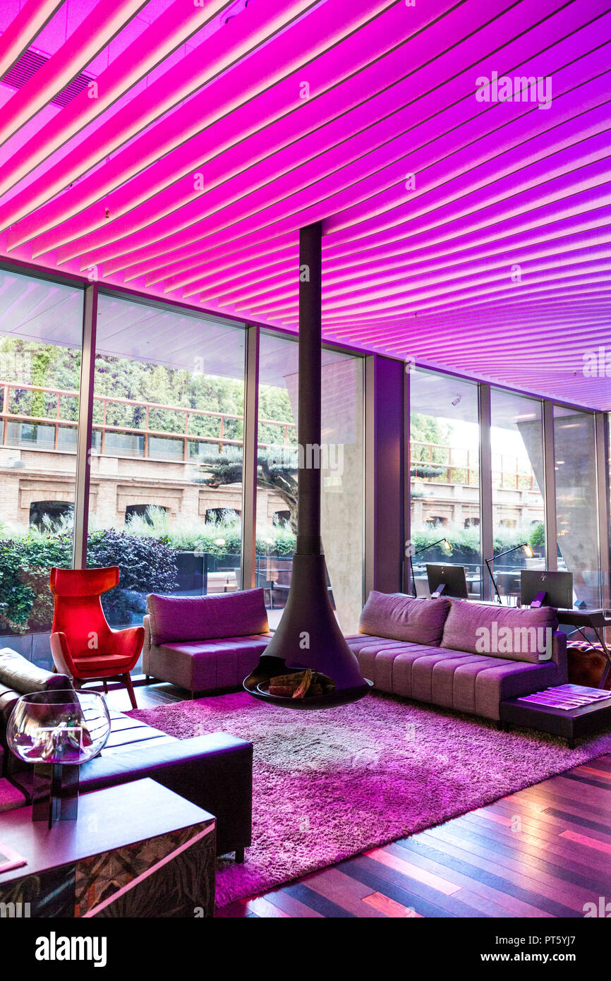 A suspended contemporary fireplace in a hotel lounge (Hotel SB Glow, Barcelona, Spain) Stock Photo