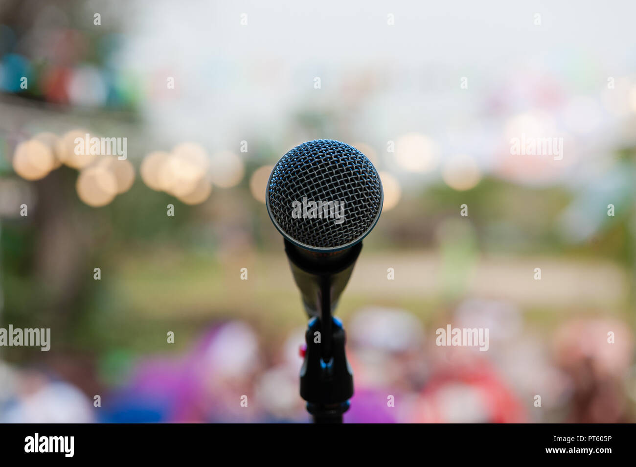 Grey microphone on the stage in bokeh Stock Photo