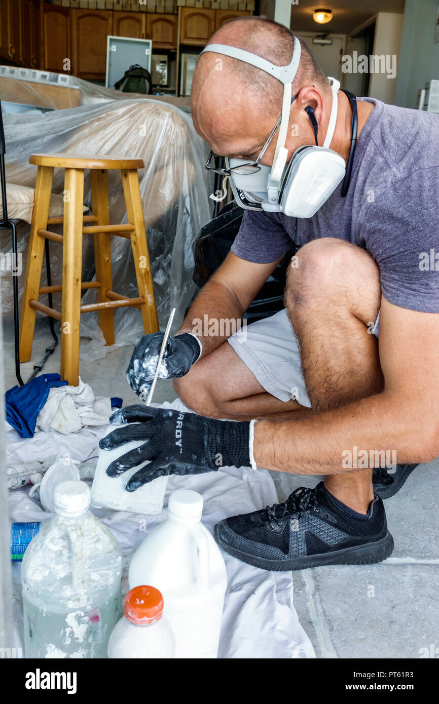 Metal spray gun for painting in a paint shop. Accessories for painting work  in a home workshop. Dark background Stock Photo - Alamy