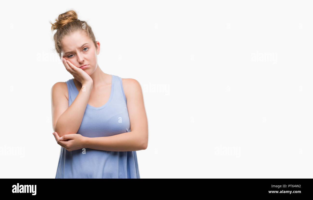 Young blonde woman thinking looking tired and bored with depression problems with crossed arms. Stock Photo