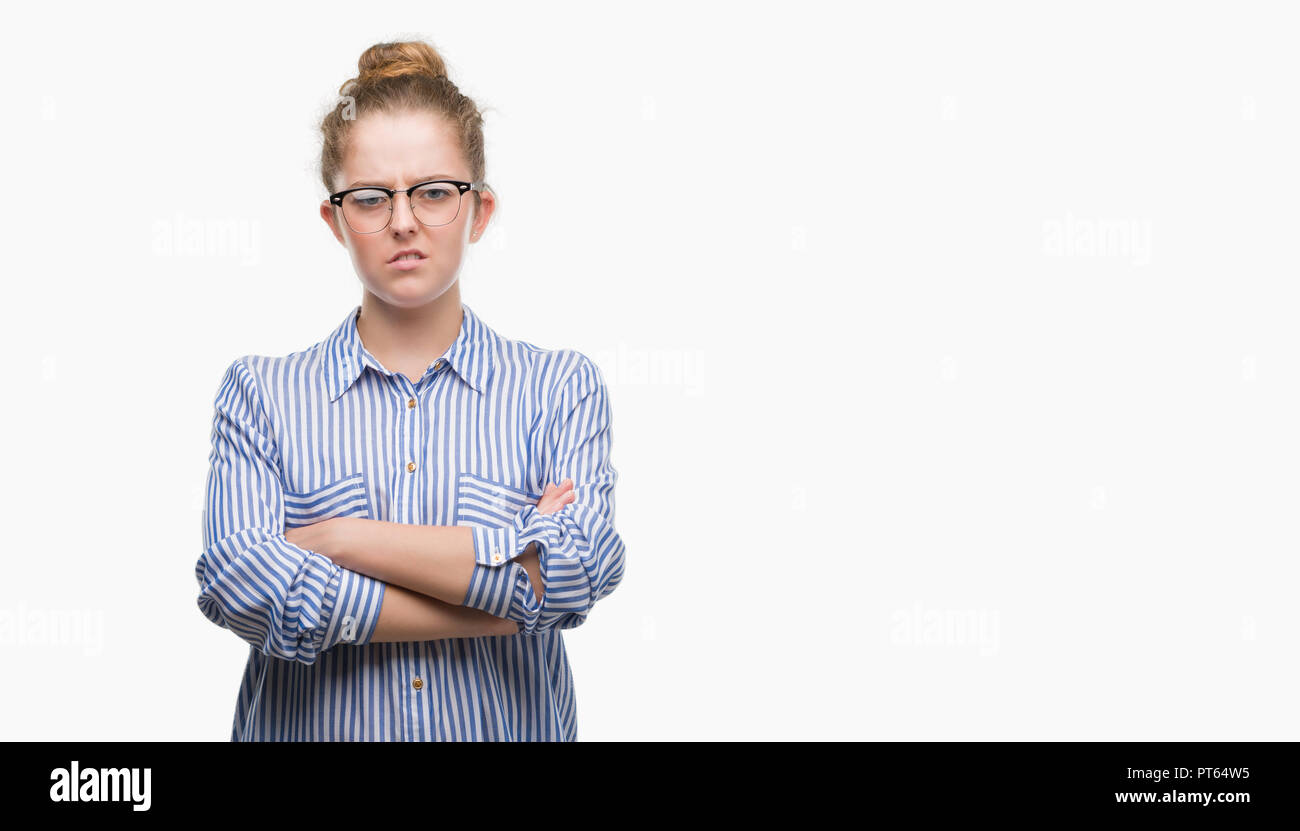 Young blonde business woman skeptic and nervous, disapproving expression on face with crossed arms. Negative person. Stock Photo