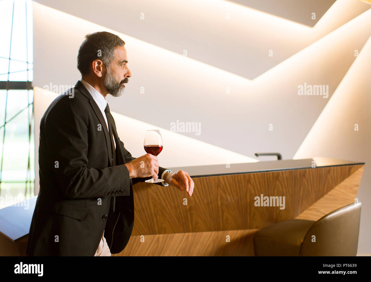 Portrait of senior handsome man drinking red wine Stock Photo