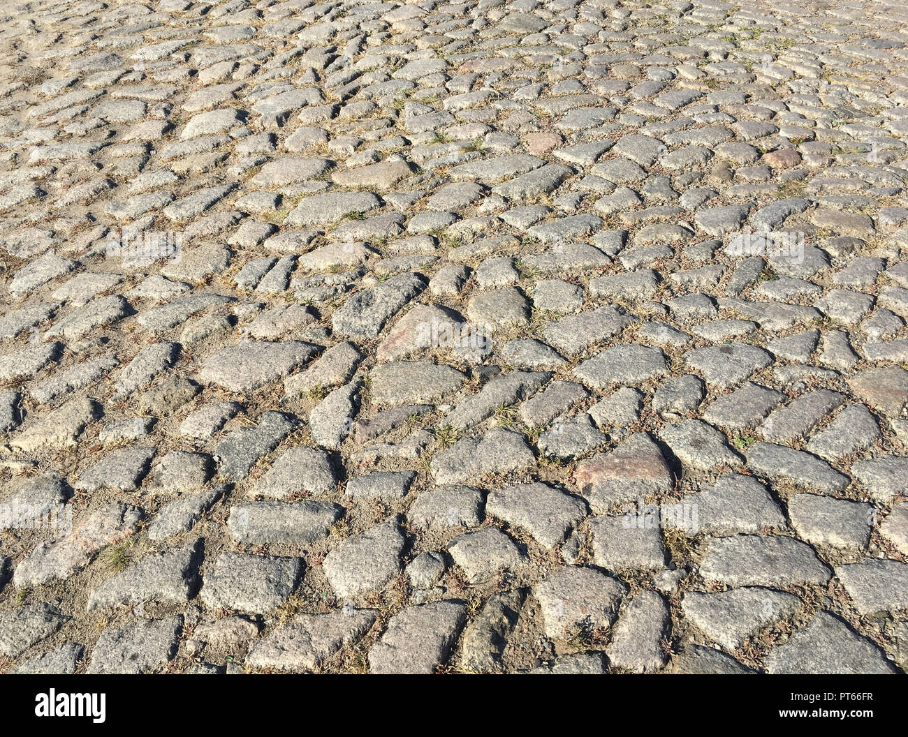Rough surface of an old cobblestone road Stock Photo - Alamy
