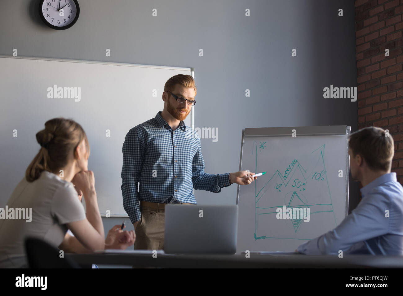 Confident male leader or business coach giving presentation to c Stock Photo