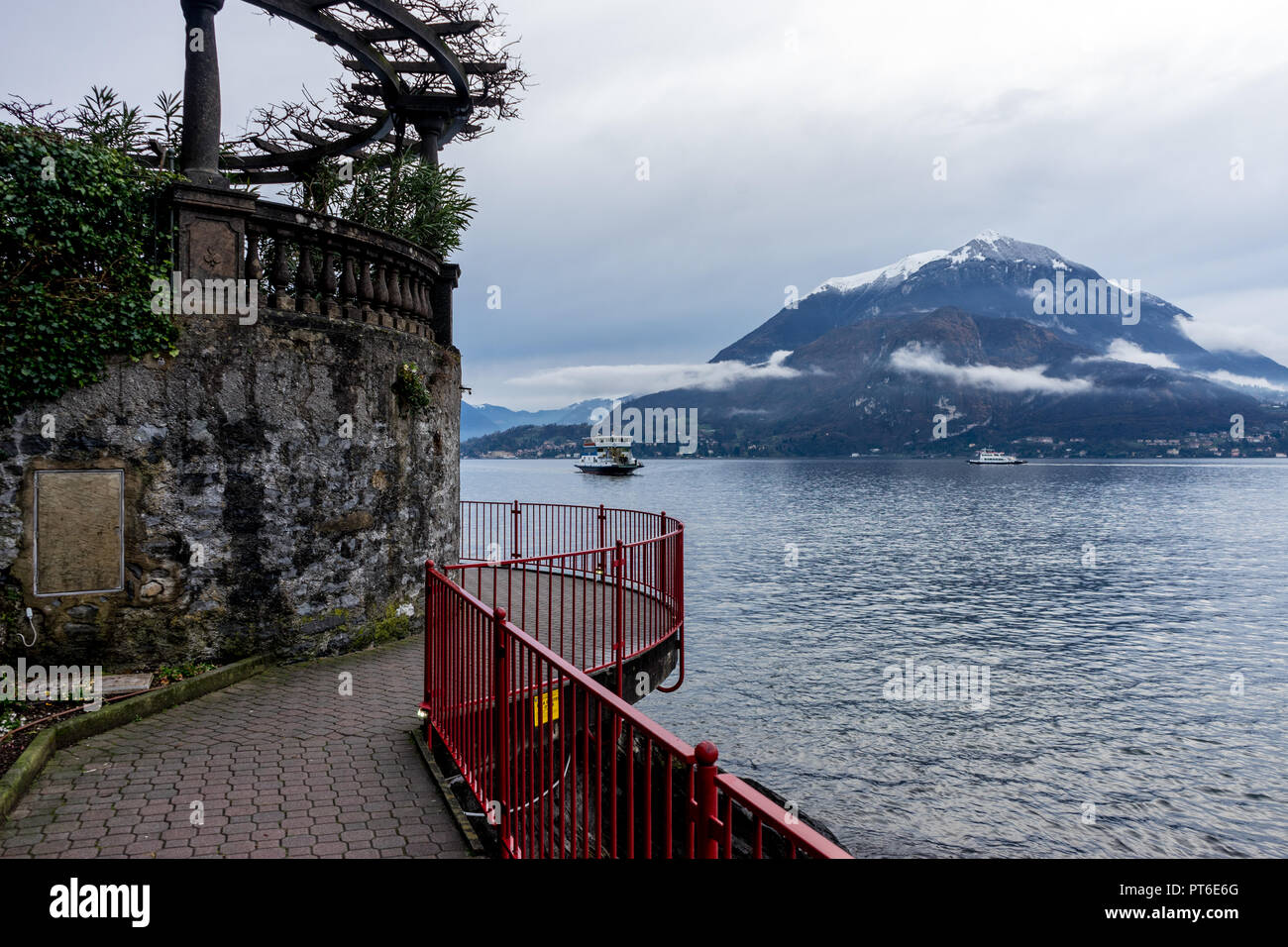 Italy, Varenna, Lake Como, boat in a serene scene with snow cap