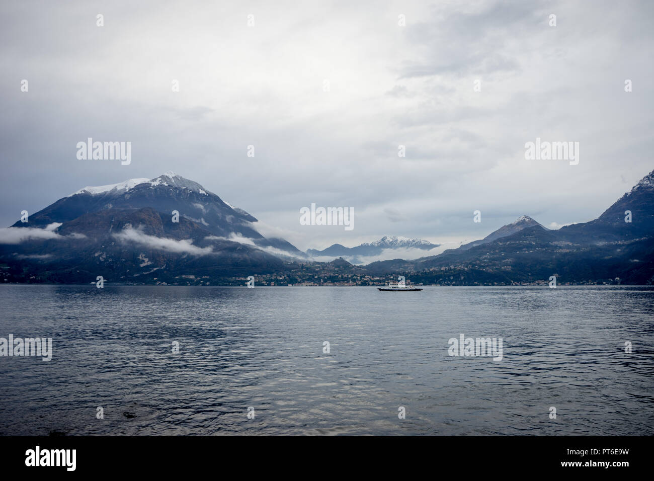 Italy, Varenna, Lake Como, boat in a serene scene with snow cap