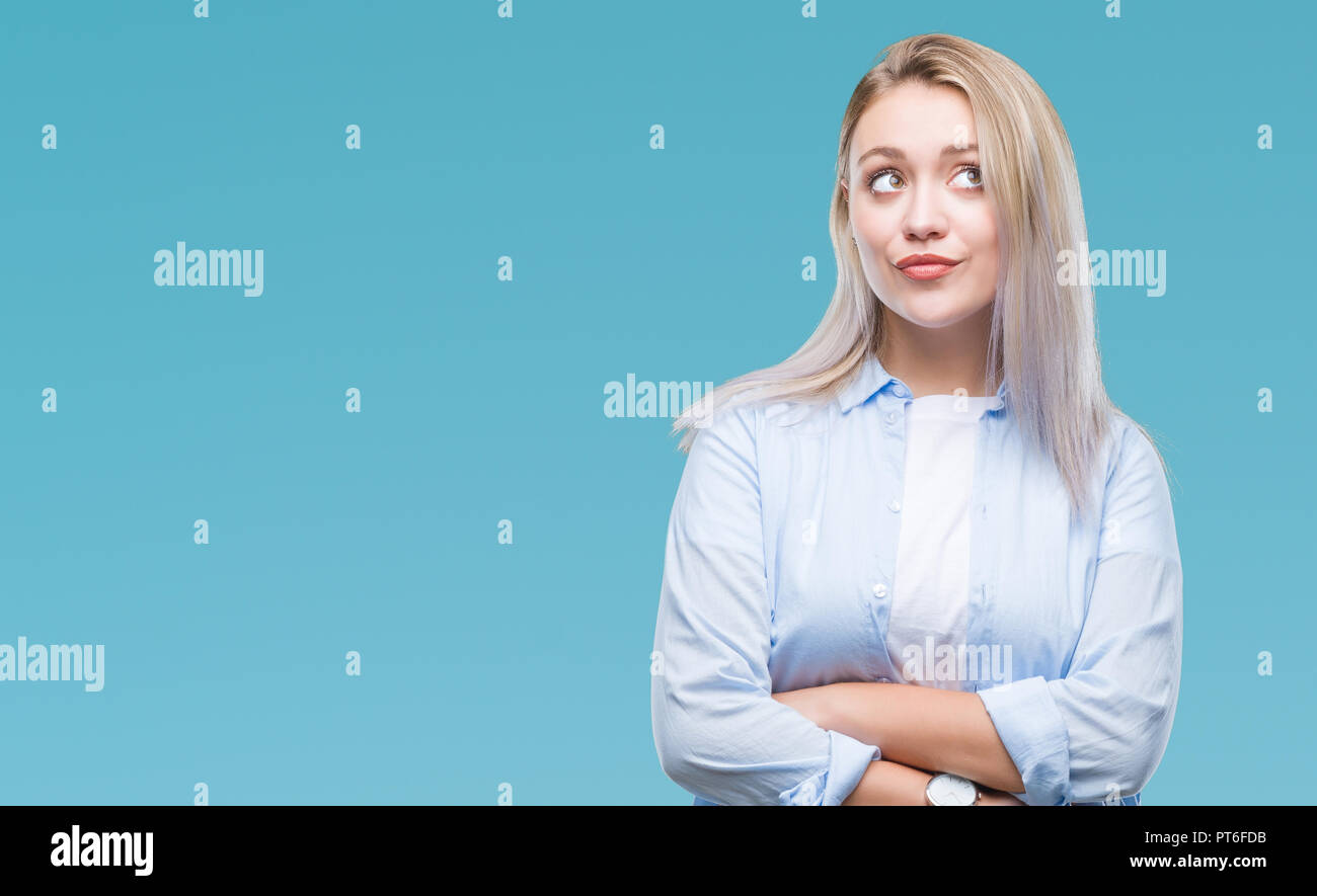Young blonde woman over isolated background smiling looking side and ...