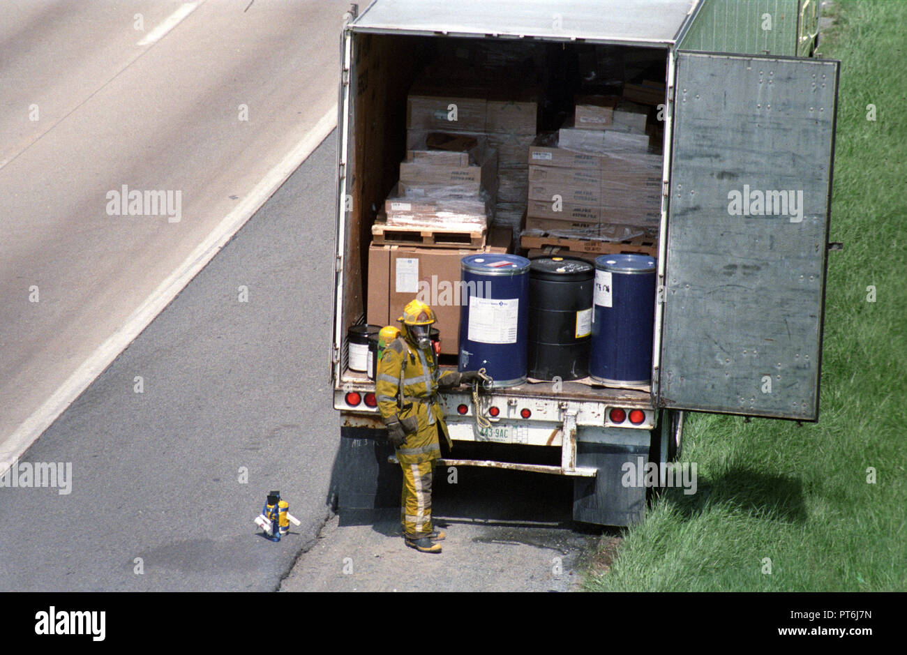 Firefighters examine hazardous cargo in the back of a tractor trailer on I95 in Beltsville, Md Stock Photo