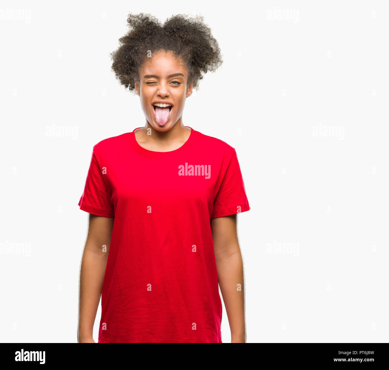 Young afro american woman over isolated background sticking tongue out ...