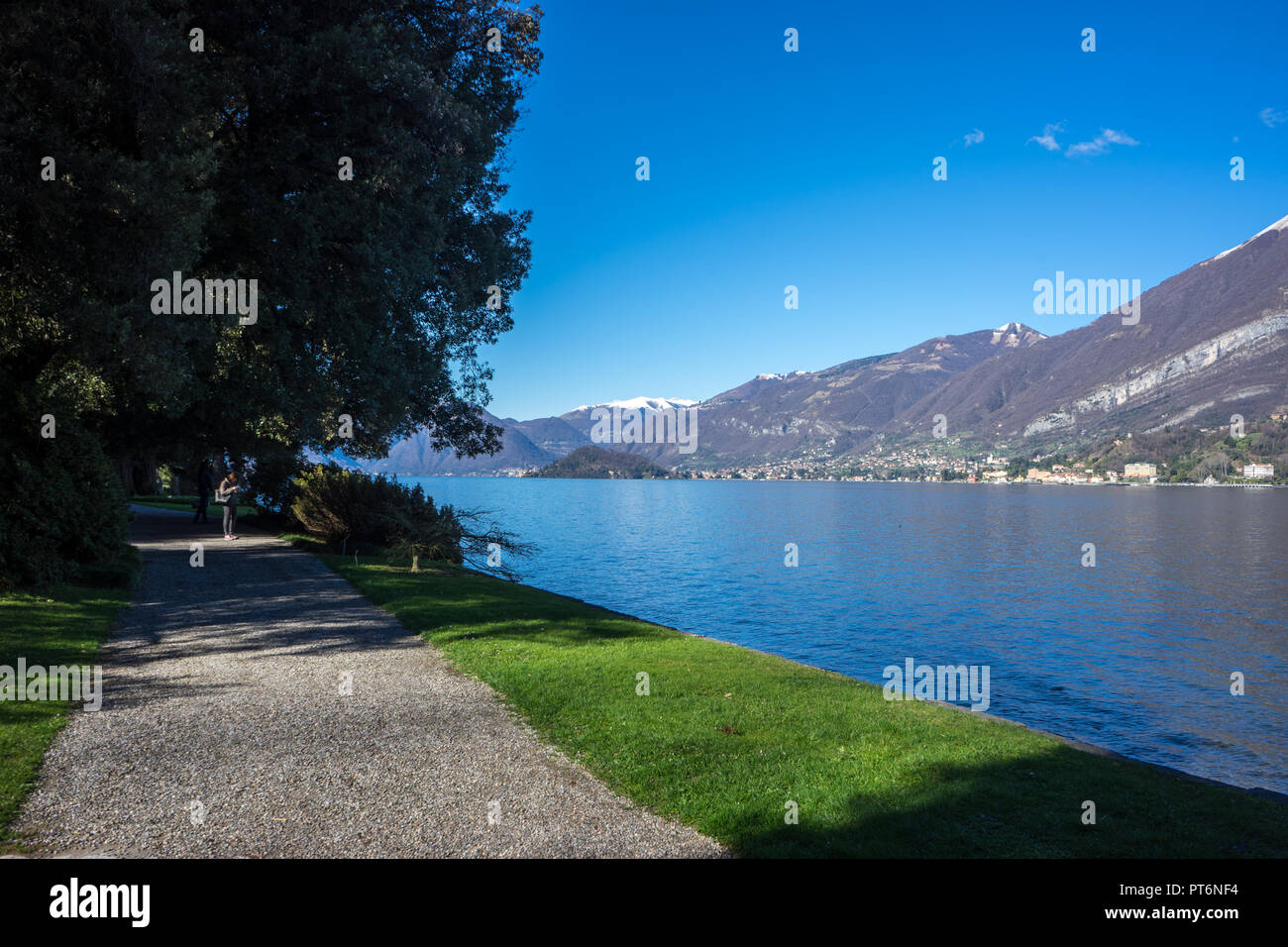 Italy, Bellagio, walking path beside Lake Como with mountain overlooking  Stock Photo - Alamy
