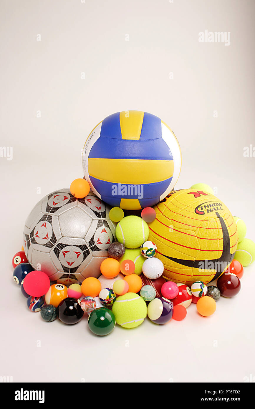 STILL LIFE OF ASSORTED BALLS OF VARIOUS SPORTS THROWBALL, VOLLEYBALL, GOLF, TABLE TENNIS, BILLIARDS, TENNIS, SNOOKER, FOOTBALL, BASKETBALL, CRICKET ON Stock Photo