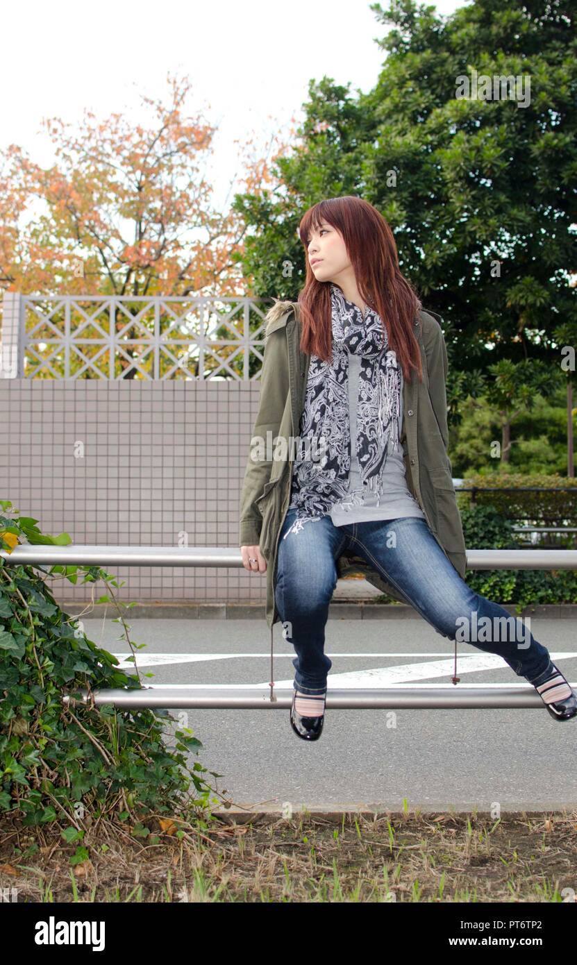Japanese Girl poses on the street in Odaiba, Japan. Odaiba is a area by ...