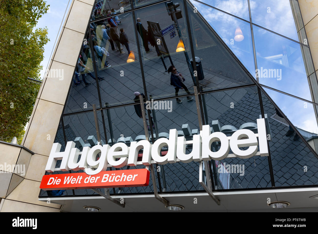 Wiesbaden, Germany, October 6th, 2018 - bookstore Hugendubel label with reflection of passing pedestrians and clients Stock Photo