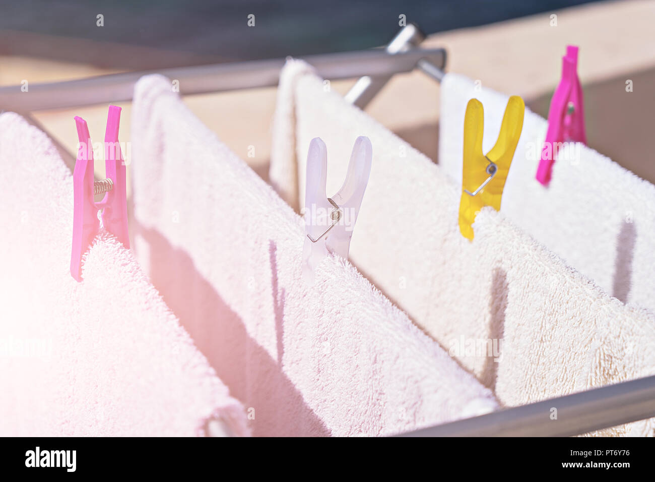 Fresh clean towels drying on washing line outdoor. Laundry hangs on the