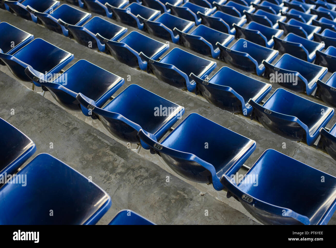 Empty sport stadium plastic chairs in a row Stock Photo