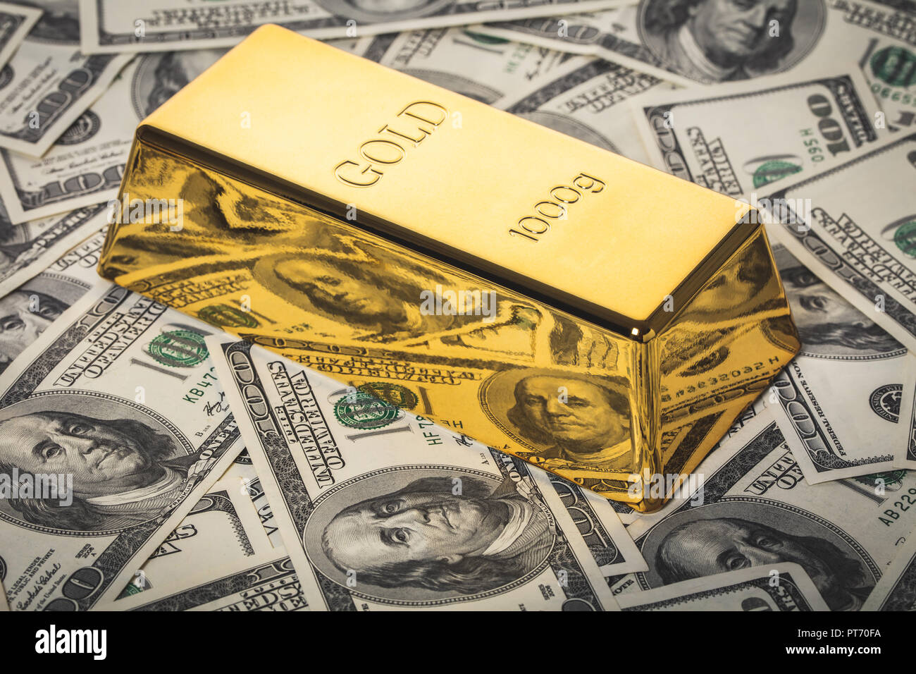 gold bar closeup on background of hundred dollar bills Stock Photo Alamy