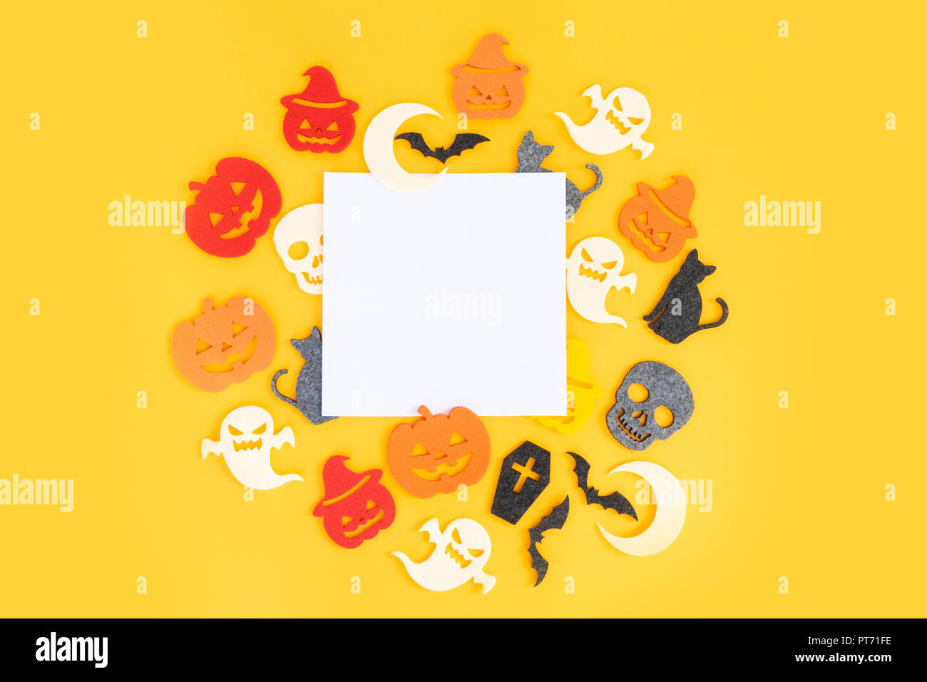 Halloween flat lay frame on yellow background with copy space on white ...