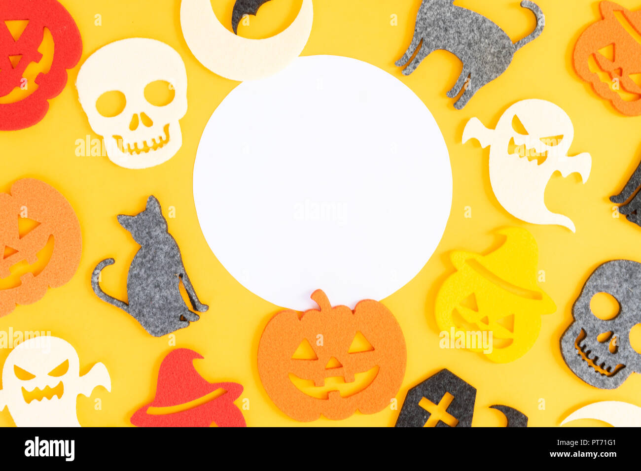 Halloween flat lay frame on yellow background with copy space on paper ...