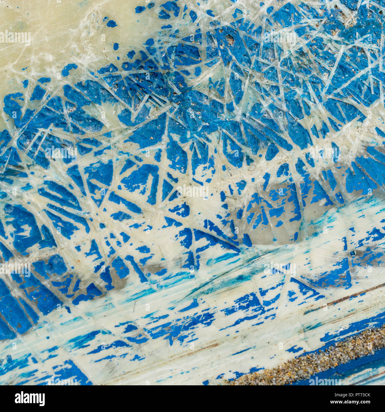 Worn bottom of a fibreglass boat hull. Old paint texture faded by time. Stock Photo