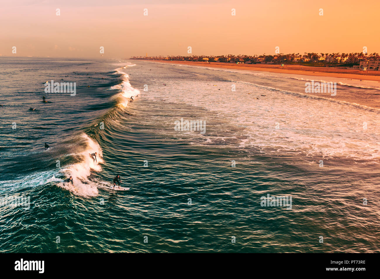 Surfers During sunrise in Huntington Beach, California Stock Photo